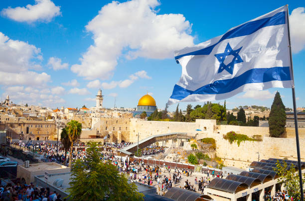 Jerusalem old city Western Wall with Israeli flag Israel flag with a view of old city Jerusalem and the KOTEL- Western wall jerusalem stock pictures, royalty-free photos & images