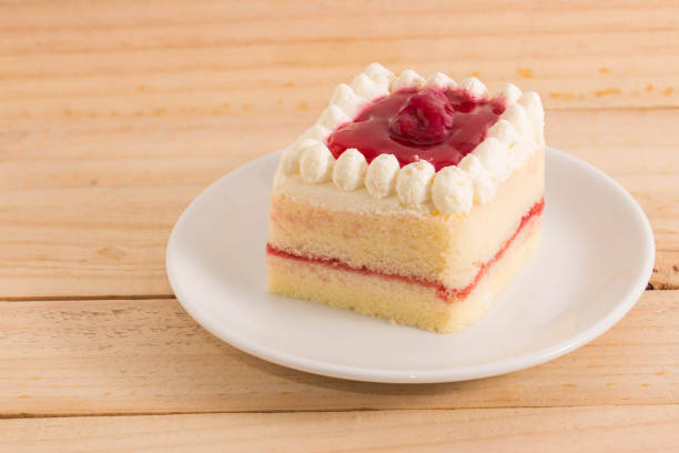 istock close up Delicious strawberries cake on plate on table on light background 641068598