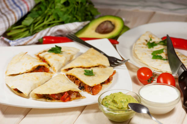istock Quesadilla with chicken, served with guacamole or salsa sauce 641071728