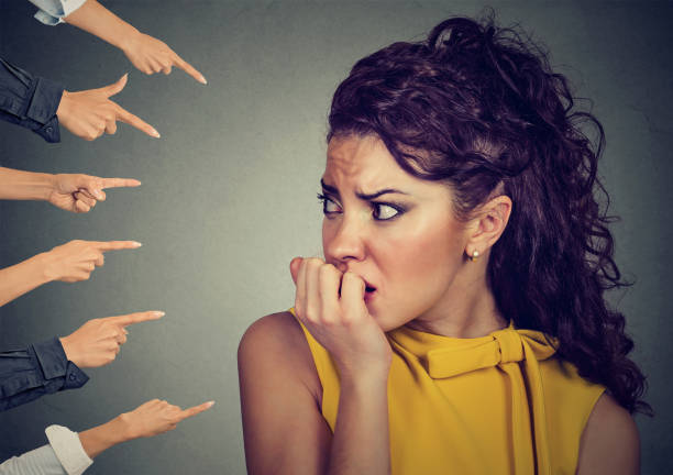 istock Anxious woman judged by different people 641079428