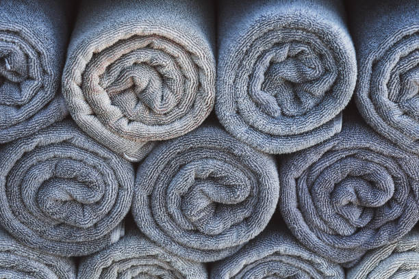 istock Stack of grey rolled towels in hotel near beach 641080164