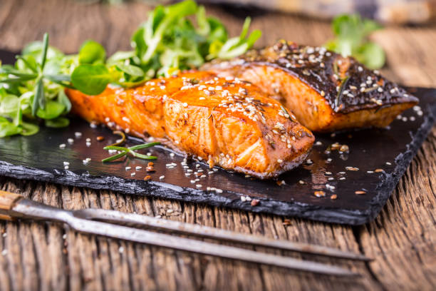 istock Grilled salmon herb decoration on vintage pan or slate board. 641080838