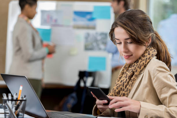 istock Pretty business professional texts while in the office 641081308