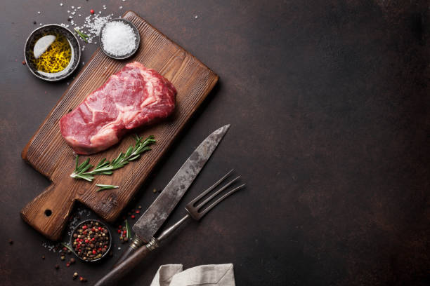 istock Raw ribeye beef steak cooking with ingredients 641083224