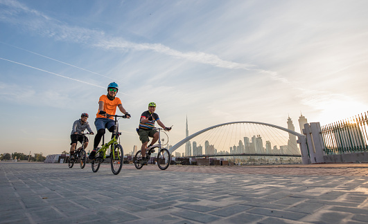 Dubai, UAE - Jan 27, 2017: Bikers in front of Dubai skyline during early morning hours.