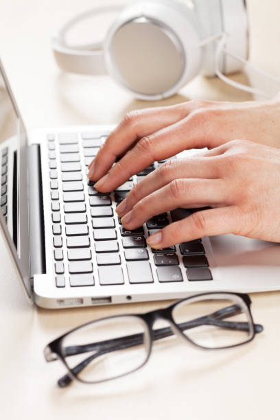 istock Woman working on laptop. Hands typing on keyboard. 641084574