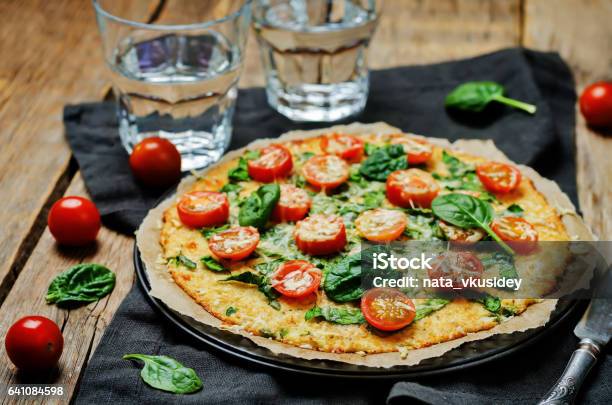 Cauliflower Pizza Crust With Tomato And Spinach Stock Photo - Download Image Now - Pizza, Cauliflower, Pastry Dough