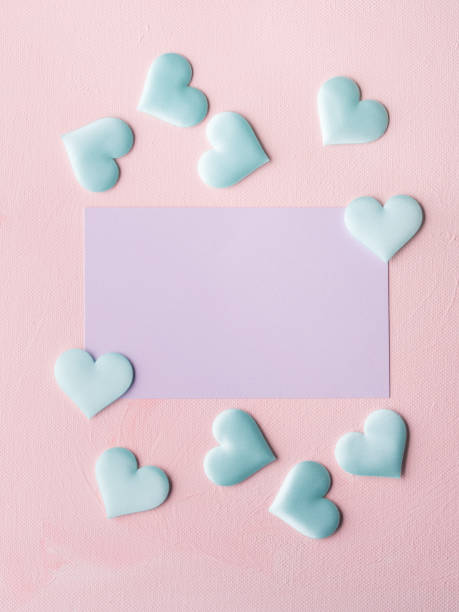 istock Purple pastel card and hearts on pink textured background 641086132