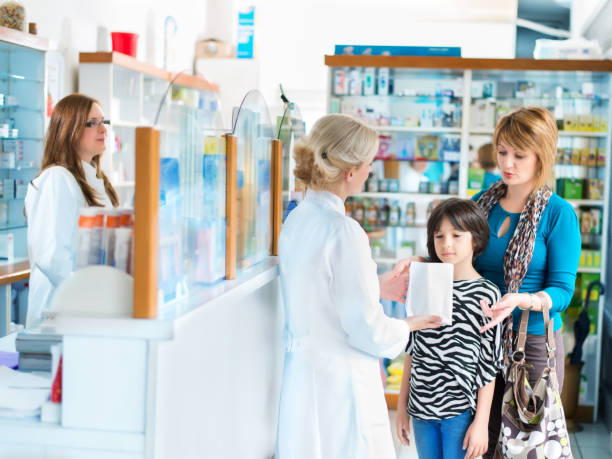 istock Pharmacist giving medication to a mother and daughter 641087084