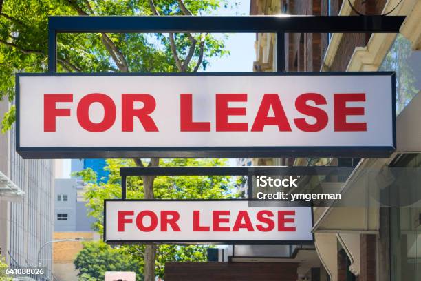 For Lease Signs On Display Outside Buildings Stock Photo - Download Image Now - Lease Agreement, Business, Sign