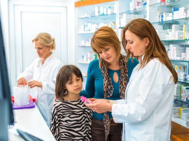 istock Pharmacist giving medication to a mother and daughter 641088794