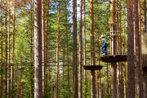 istock Girl on hinged trail in extreme rope Park 641089492