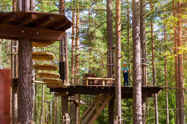 istock Girl on hinged trail in extreme rope Park 641090806