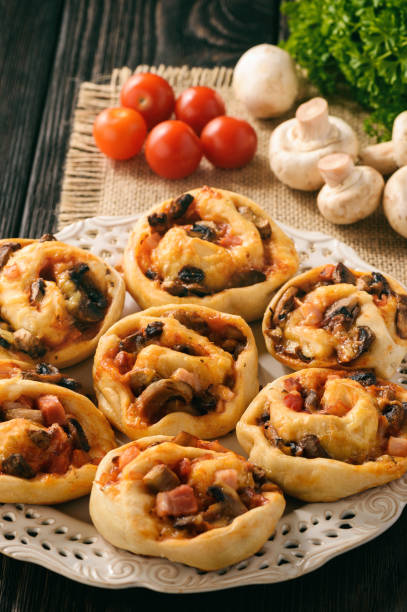 istock Pizza rolls with tomato sauce, bacon, mushrooms and cheese. 641092732