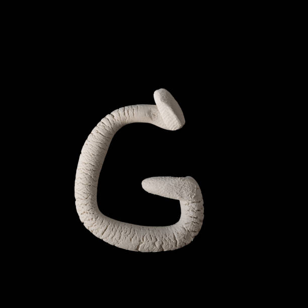 istock Alphabet G mold by clay on brown wooden 641093102