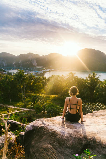 Woman looking at view of Koh Phi Phi at sunset