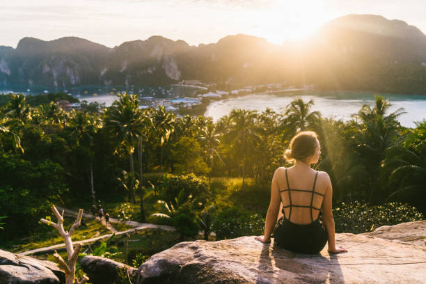 istock Woman looking at view of Koh Phi Phi at sunset 641112364