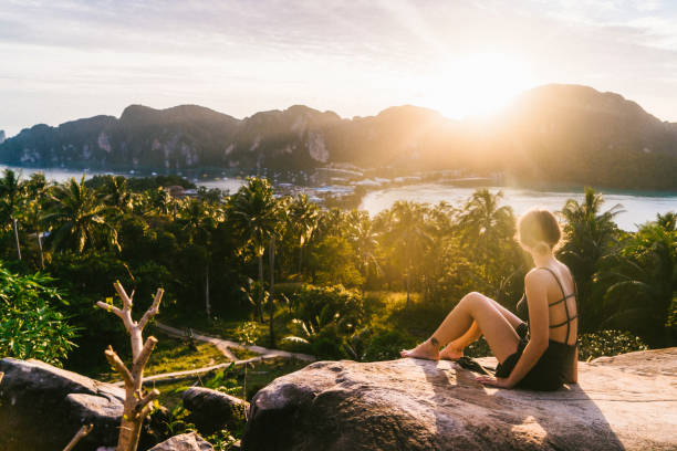 istock Woman looking at view of Koh Phi Phi at sunset 641112366