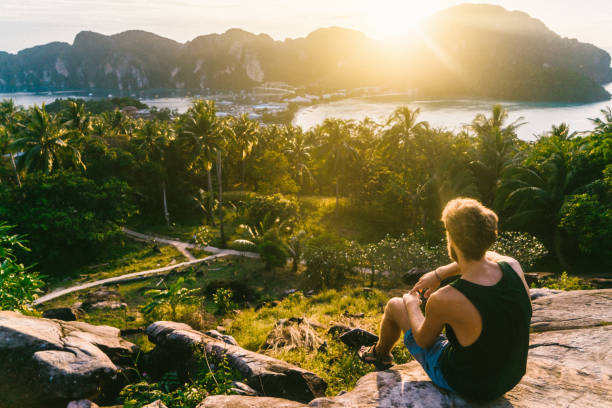 istock Man looking at view of Koh Phi Phi at sunset 641112402