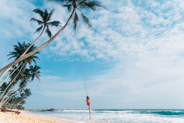 istock Woman playing on rope swing 641113524