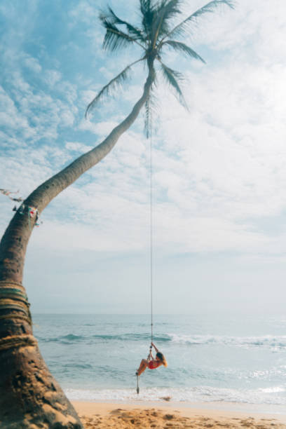 istock Woman playing on rope swing 641113532