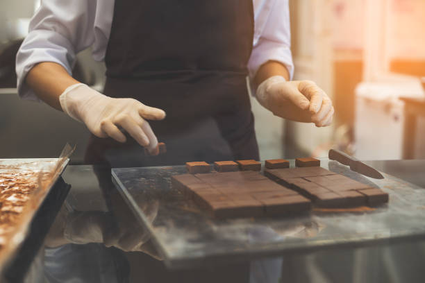 istock Chef cutting homemade chocolate in kitchen. 641117584