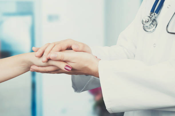 istock Doctor holding patient hand close up 641118514