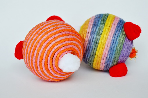 dog and cat toy ball wrap colorful hemp rope on white background