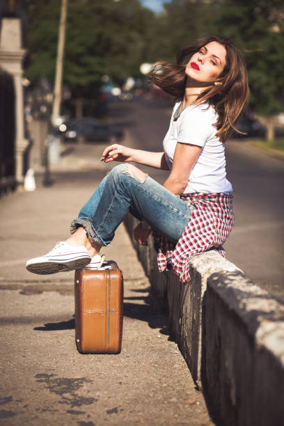 istock Woman with a suitcase in the city 641119496