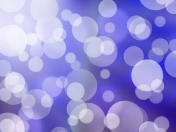 Abstract Blurred Bokeh on blue and navyblue gradient background.