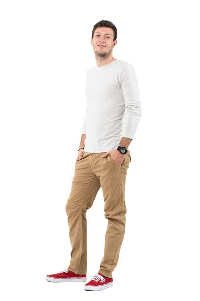 istock Cool young man with hands in pockets smirking at camera 641123722