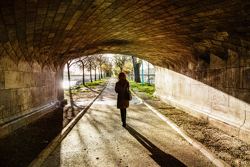 Woman walking under old bridge, Pont Rouelle , Paris, France