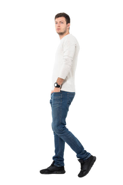 istock Casual man in jeans walking and looking at camera 641124270