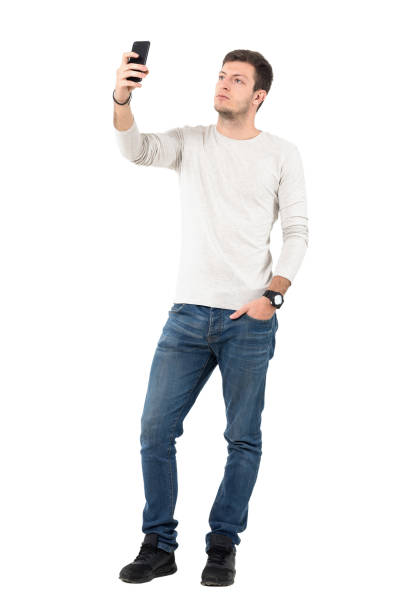 istock Young handsome man taking photo with cell phone 641124302