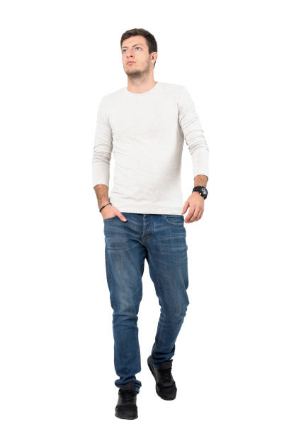 istock Relaxed young casual man walking towards camera looking up 641124324