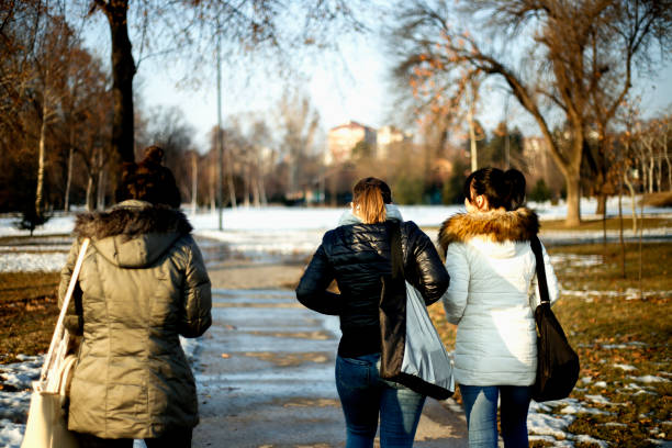 istock Three young women walking in sunny day in the park 641126124