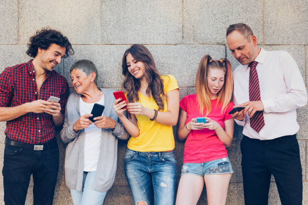 istock Various ages people texting and sharing outdoors 641126456
