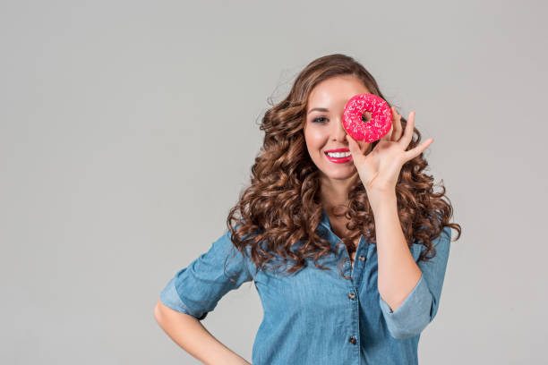 istock The smiling girl on gray studio background with round cake 641131576