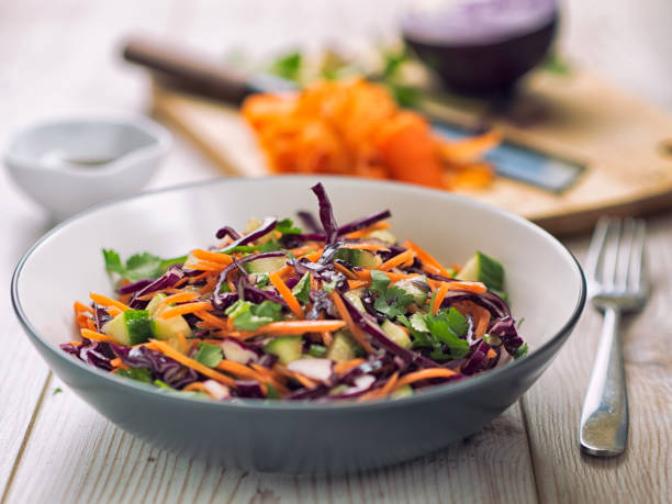Healthy slaw Home made oriental style healthy slaw,made by sliced red cabbage,carrots,cumcumber,and coriander.mix with soy sauce and rice vinegar,mustard seeds. coleslaw stock pictures, royalty-free photos & images
