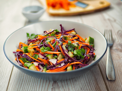 Home made oriental style healthy slaw,made by sliced red cabbage,carrots,cumcumber,and coriander.mix with soy sauce and rice vinegar,mustard seeds.
