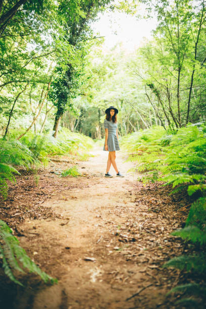 istock Girl with hat enjoying nature in the forest 641134218