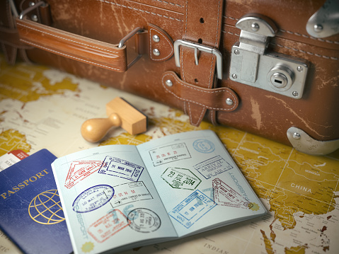 Travel or turism concept.  Old  suitcase  with opened passport with visa stamps. 3d illustration


