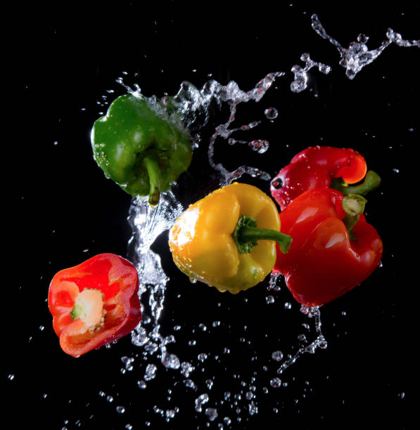 istock Bell peppers with splash isolated on black background, motion action. 641136414