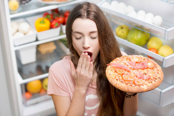 istock Woman with food near refrigerator 641147868