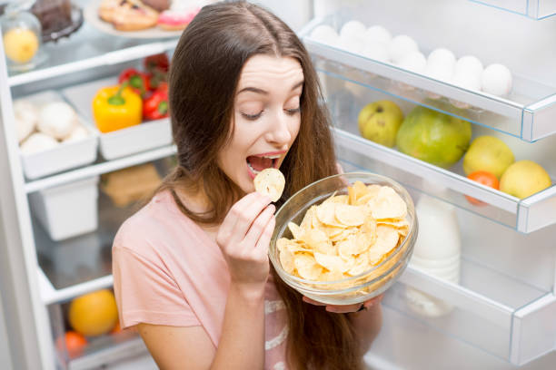 istock Woman with food near refrigerator 641147872