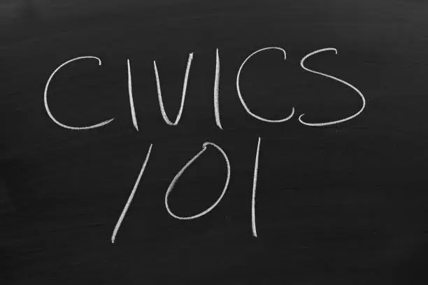 The words "Civics 101" on a blackboard in chalk