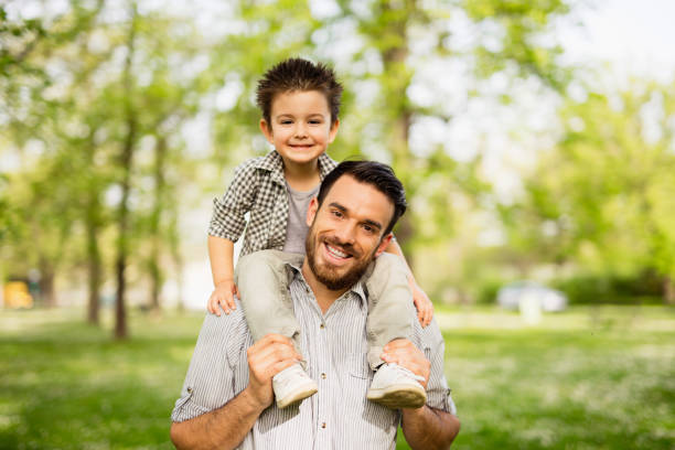 istock Smiling father is carrying his son on his shoulders. 641151304