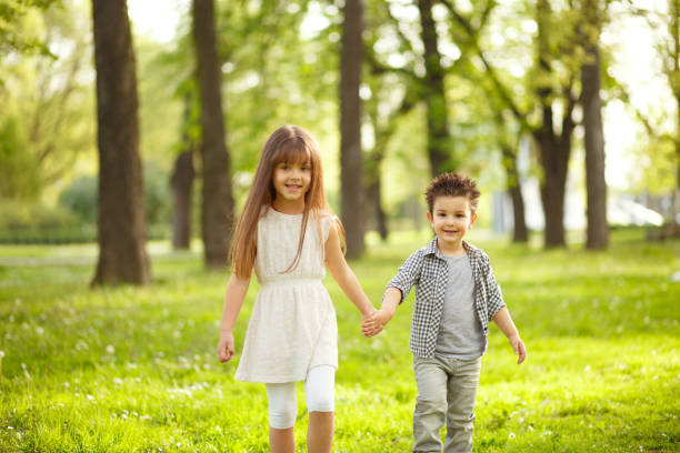 istock Two kids holding hands in nature and having fun. 641151392