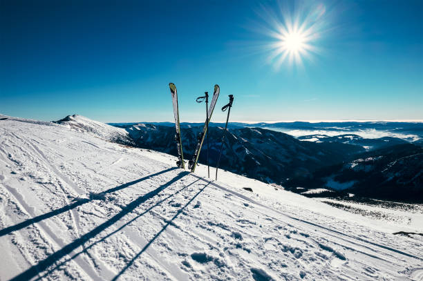 istock Skis are in deep snow on the ski track in sunny bright light 641154372