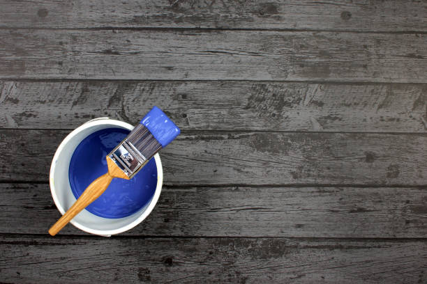 istock Paintbrush on a pot of blue paint 641154516